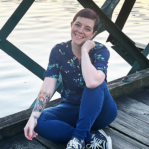 Kristy Gonyon sitting on a bridge over a river